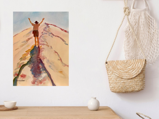 artwork featuring a man climbing towards the top of an enormous sand dune
