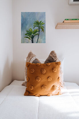 two birds of paradise palms painted against a delicately toned blue sky