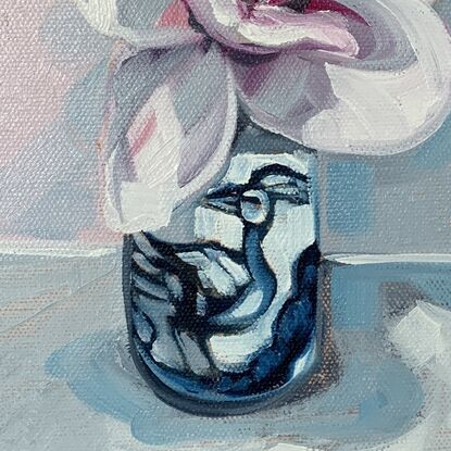 white and pink blush magnolia flowers in a blue and white bird vase