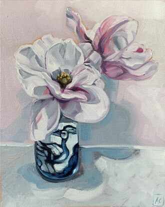 white and pink blush magnolia flowers in a blue and white bird vase