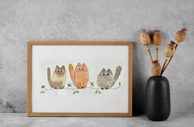 Three little cats against a white background