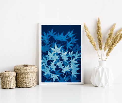 Image of branches of maple leaves in varying shades of blue. It is technically a photo but has the texture of a painting.