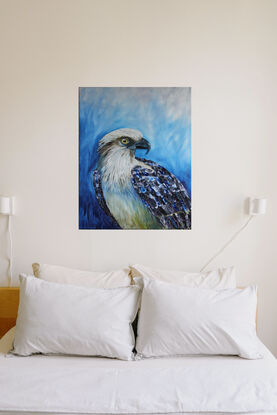 a large osprey stares back at the viewer cropped close with a swirling blue background