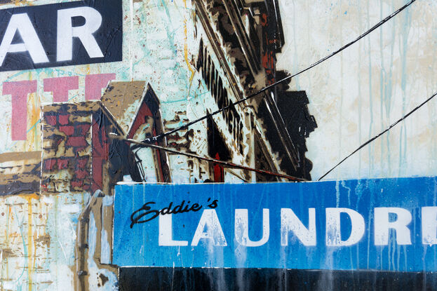 on old building with faded signage looms over the viewer.