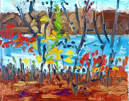 Bright colored bushes and against the backround of lake, distant shore and sky 