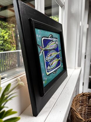 Silver coloured fish on a dish , 3 fish on an enamel dish, blue green sea and fish, pretty coloured fish, blue enamel dish with silver fish, kitchen dish and fish, sardines, whimsical, aqua, dark blue.
