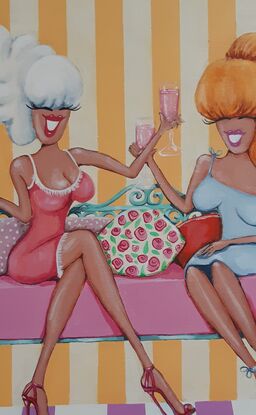 Two women drinking pink champagne sitting amongst shopping bags