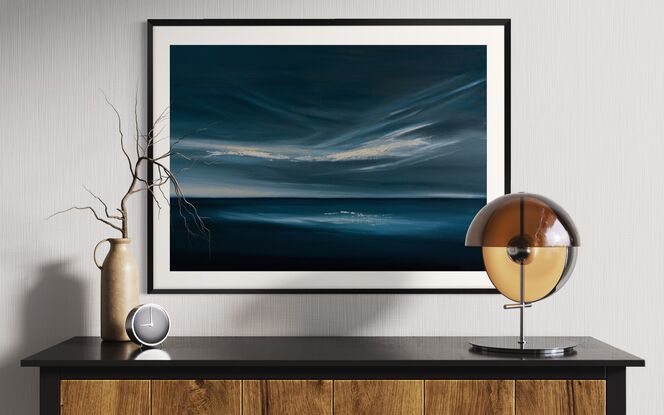 Dark blue ocean and sky with light through clouds and on the horizon. Light reflected on deep blue water. Framed and ready to hang. Modern expressive cloudscape over ocean in deep blue