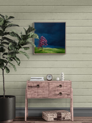 Australian landscape with deep blue skies, vibrant green hills and a red tree in the foreground