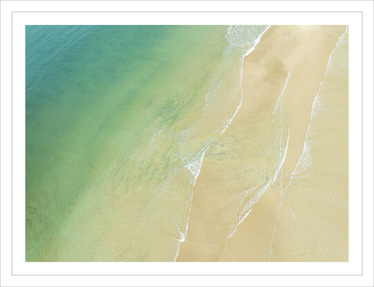 Coastal aerial photo of water and sand beach and summer vibes.