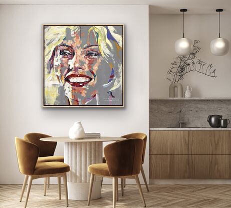 Portrait of Debbie Harry on a neutral grey background. Pops of colour make up the face. 