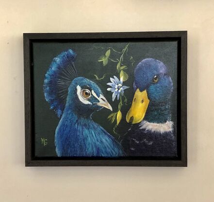 A blue peacock with a blue duck who are best friends