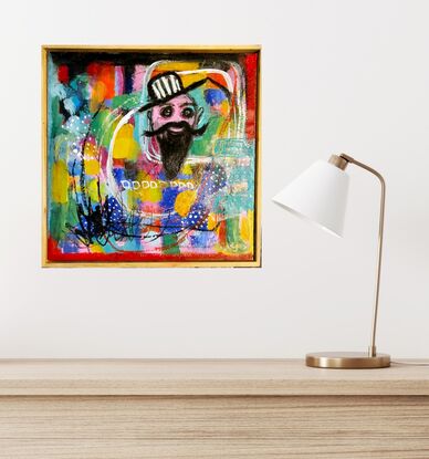 A fun piece with bright colours of blue, green,  pink, yellow and red with a male face with a moustache like Dali's and a beard. He is wearing a black and white striped, brimmed hat. 