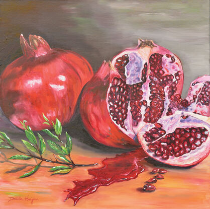 Pomegranates, whole and cut, with juices flowing