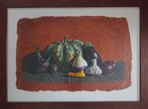 A large striped pumpkin surrounded by a variety of purple vegetables sitting on an old timber bench.