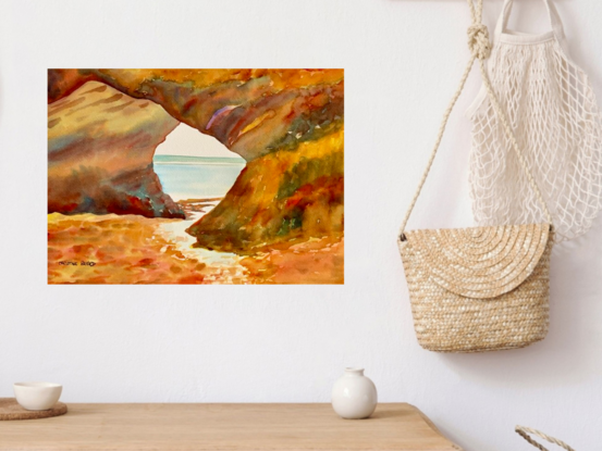 artwork showing a rocky outcrop forming a tunnel onto a beach