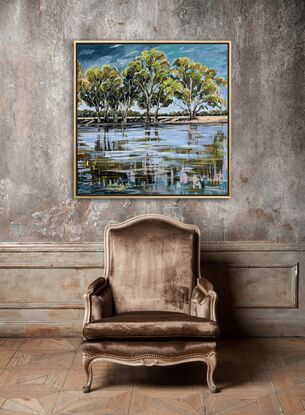 Gum trees line the edge of the Murray river with a beautiful reflection in the water. 