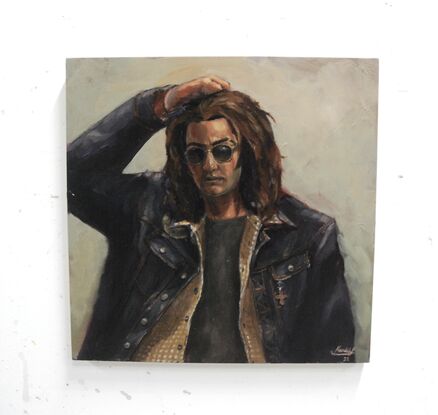 A portrait of a person with shoulder length curly brown hair, wearing sunglasses and a denim jacket with a flannel shirt over a grey t-shirt. There is a green synthetic glow to the lighting and the figure's posture seems tired and frustrated. By H. Fleming