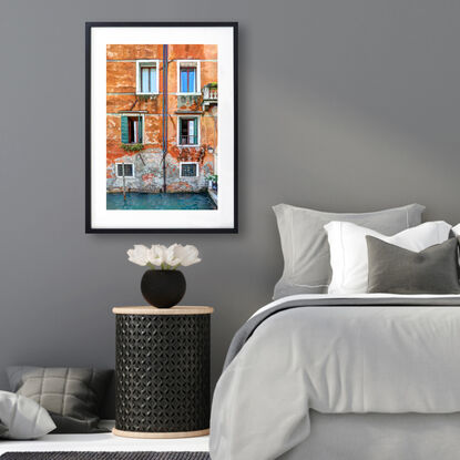 Waterfront wall and windows on canal in Venice, Italy