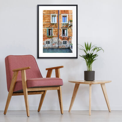 Waterfront wall and windows on canal in Venice, Italy