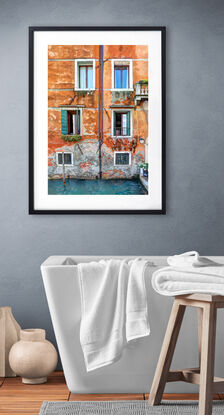 Waterfront wall and windows on canal in Venice, Italy