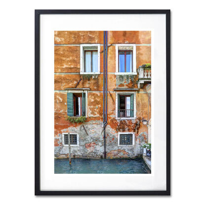 Waterfront wall and windows on canal in Venice, Italy