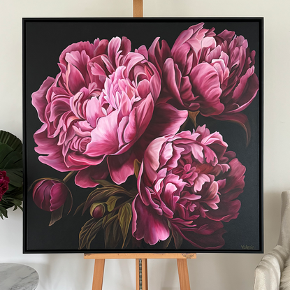 Close up of three deep pink peonies against a dark background