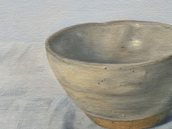 Little pot on a white cloth.