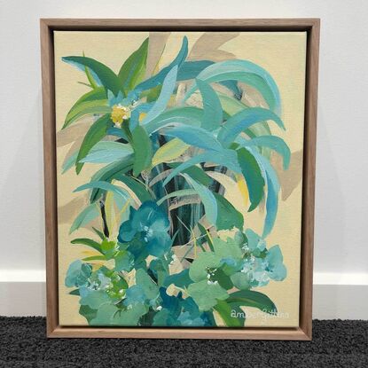 small framed original painting of a tropical island theme with green and blue palm trees, tropical flowers and a yellow background.