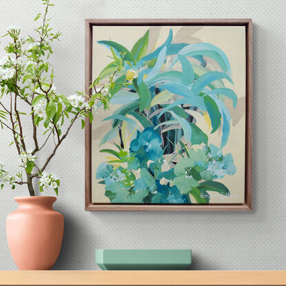 small framed original painting of a tropical island theme with green and blue palm trees, tropical flowers and a yellow background.