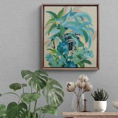 small framed original painting of a tropical island theme with green and blue palm trees, tropical flowers and a yellow background.