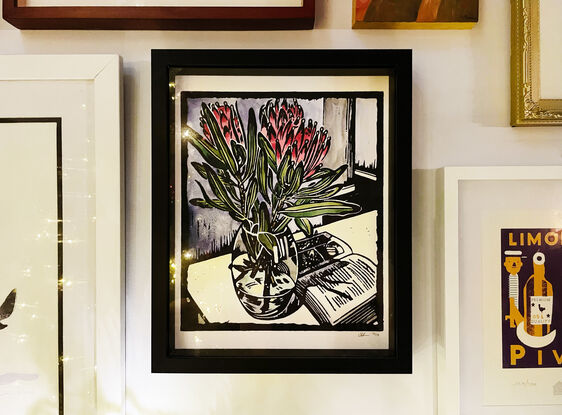 linocut of proteas and book