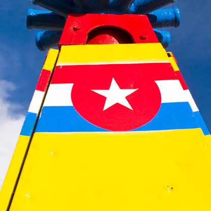 A brightly coloured retired sideshow ride