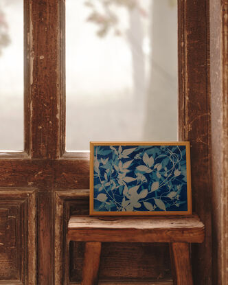 Image of branches of jasmine flowers and leaves in varying shades of blue and white. It is technically a photo but has the texture of a painting.