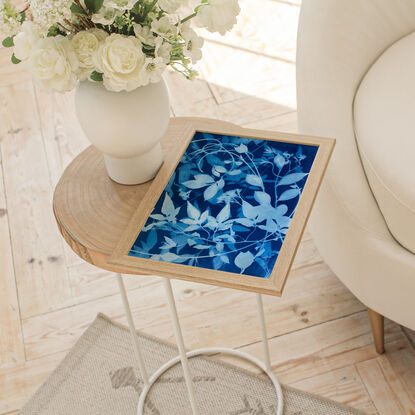 Image of branches of jasmine flowers and leaves in varying shades of blue and white. It is technically a photo but has the texture of a painting.