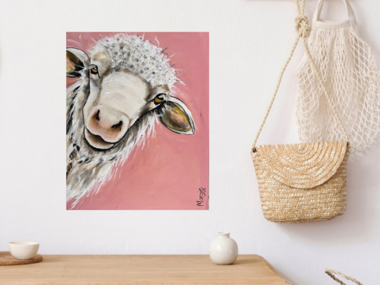 A young sheep with an inquisition expression staring out from the canvas with a peach pink background.