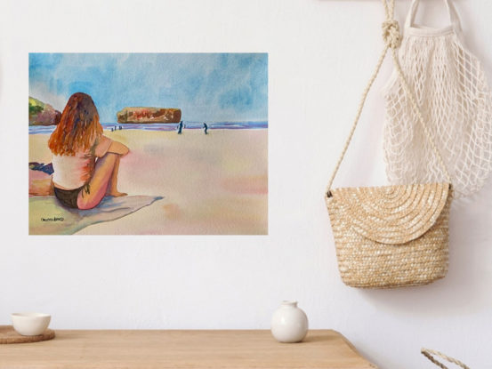 artwork showing a woman in bikini sitting on the beach watching people playing at the edge of the water
