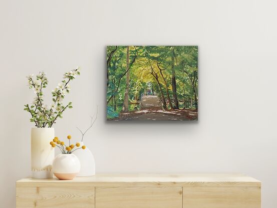 A forest scene with a small bridge in the center and a couple framed by the trees.