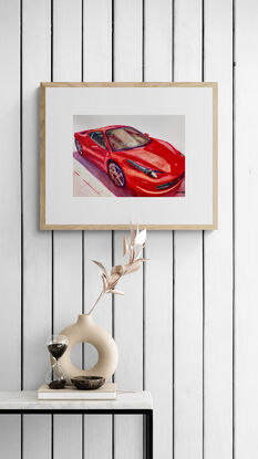  artwork showing a red ferrari gleaming in the sunshine
