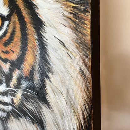 Painted in rich hues this artwork captures the intense gaze of a tiger. This artwork is  unframed 