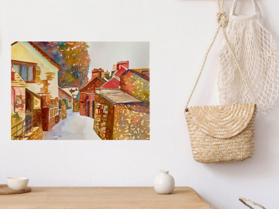 artwork showing a narrow winding street of dry stone walled cottages in a village located in the Lake District in Cumbria, England