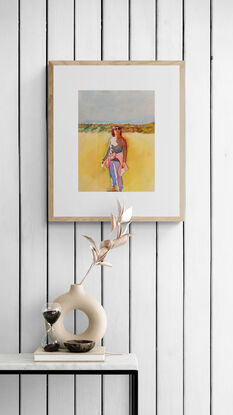 artwork showing a woman standing on a beach with grassy topped dunes in the distance