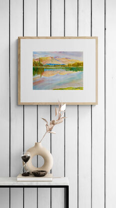 artwork showing a sunny day landscape vista with distant fells and a mirror lake reflection
