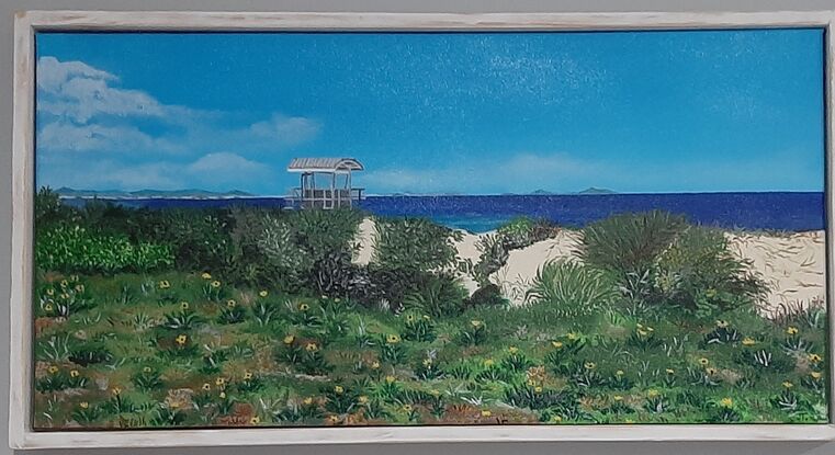 The beach with grassland and wild flowers and a lifeguard tower