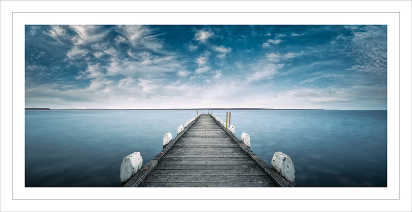 Grantville jetty calm ocean water with blue cloudy skies