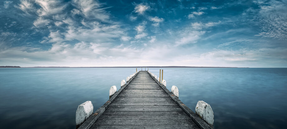 Grantville jetty calm ocean water with blue cloudy skies