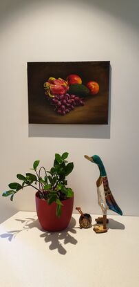 Dragon fruit with grapes, avocado and apples in the background.