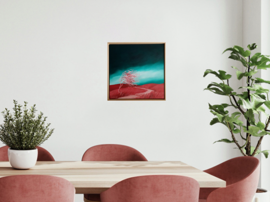 Australian landcape with vibrant grren windswept sky and red/pink hills and tree in the foreground, framed