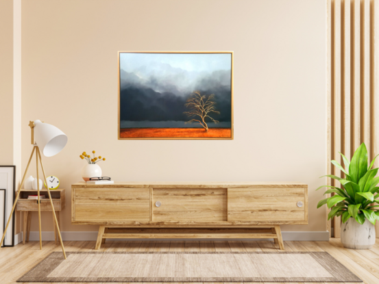 Australian landcape with  burnt orange grasses, deep blue grey cloudy sky and an old tree in the foreground