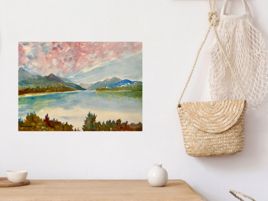 artwork showing a landscape vista with distant fells and a mirror lake reflection


